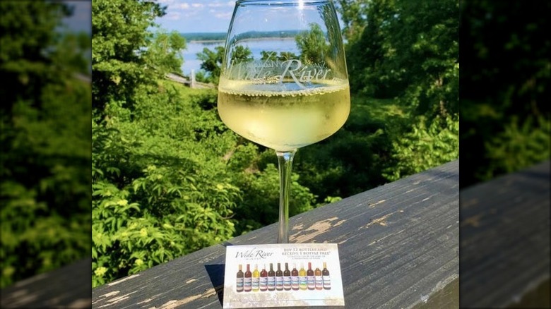glass of white wine on deck overlooking the Mississippi River