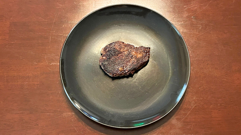 Longhorn Steakhouse Renegade Sirloin on a black plate against a wood surface