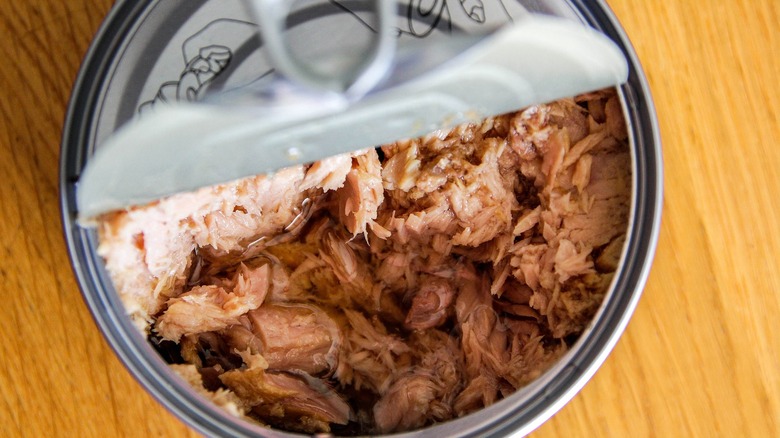 a can of tuna viewed from above with lid slightly open