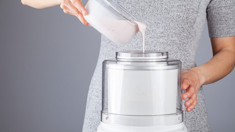 woman pouring a chilled ice cream base into an ice cream maker