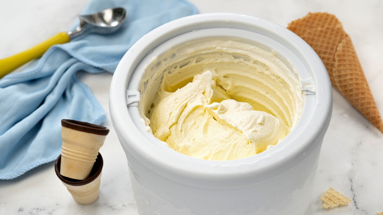 Homemade vanilla ice cream in the freezer bowl of an ice cream maker
