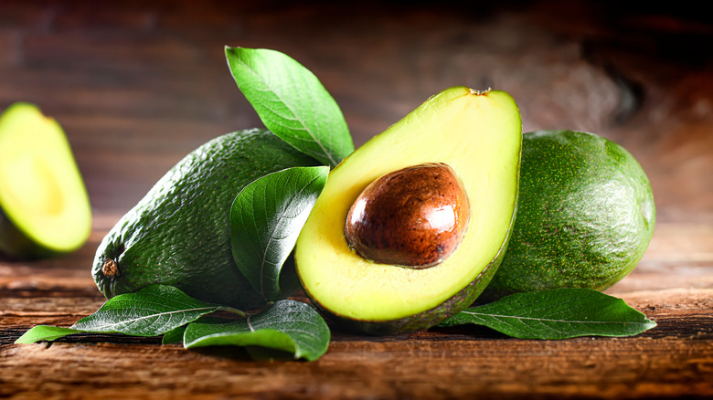 Avocado half with pit in