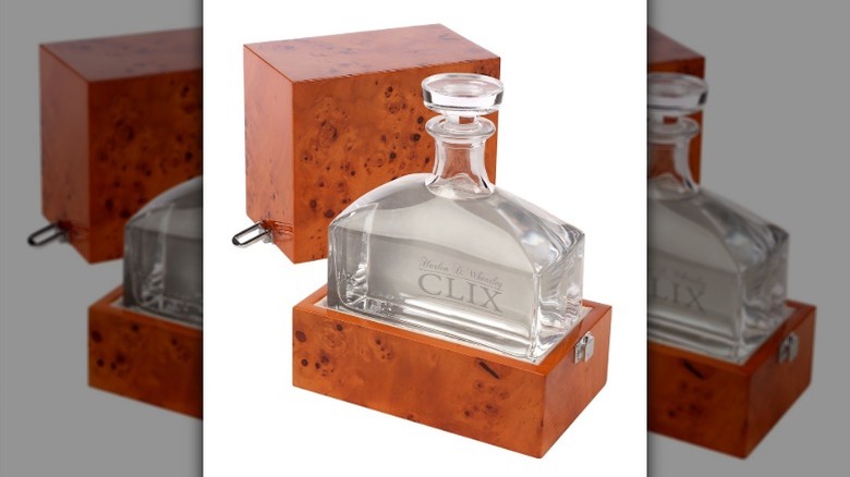 A bottle of CLIX Vodka enclosed in a wooden case