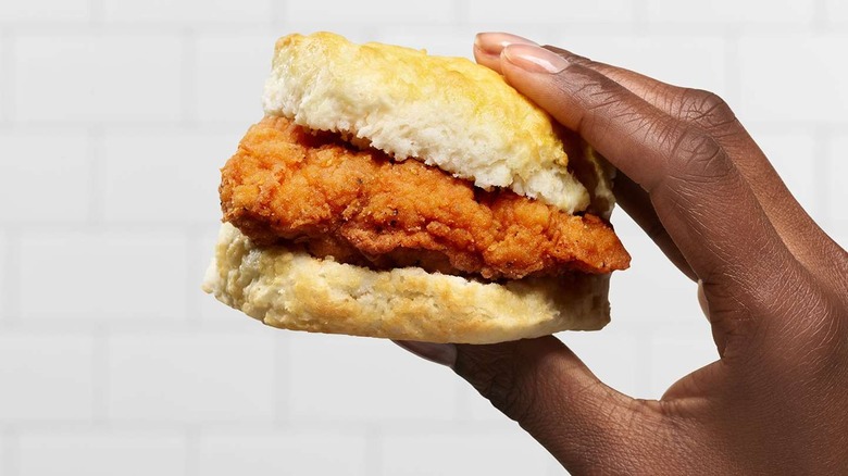 a chicken biscuit from Chick-Fil-A held up against a white background.