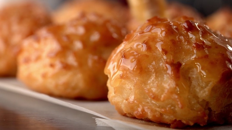 glistening honey butter biscuits arranged on wax paper.