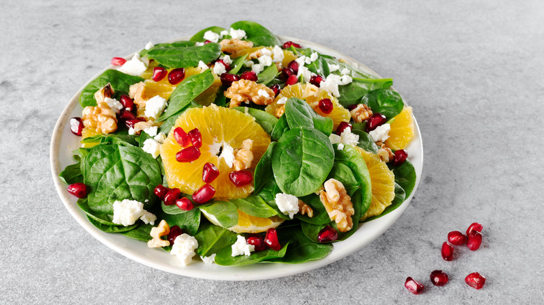 Salad with oranges and pomegranate seeds, feta, and walnuts