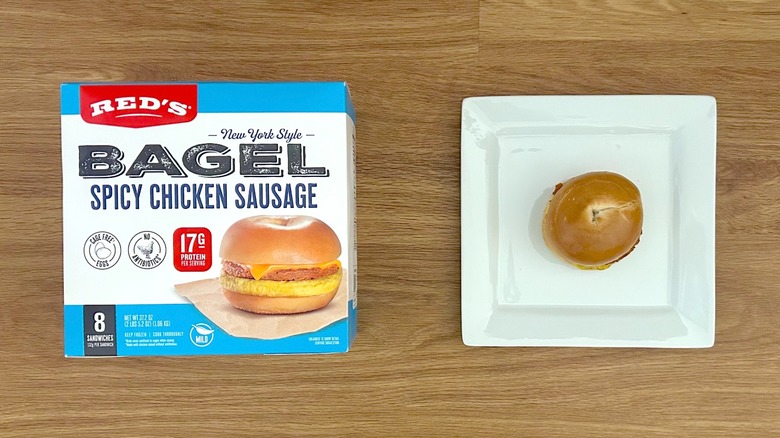 Package and serving of Red's New York Style Bagel Spicy Chicken Sausage on square white plate