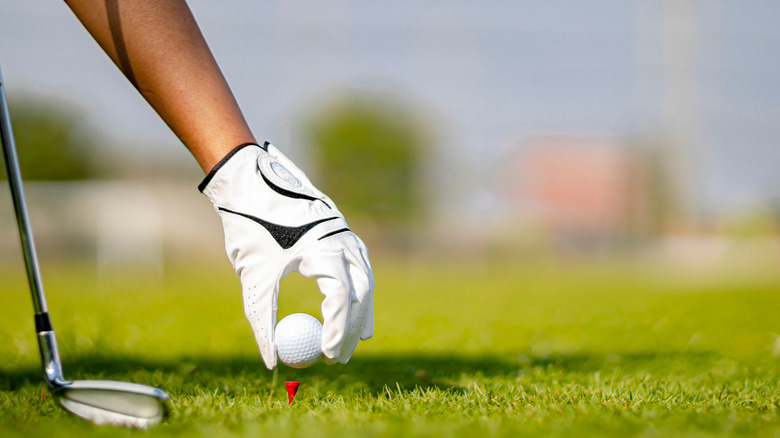 golfer placing the ball