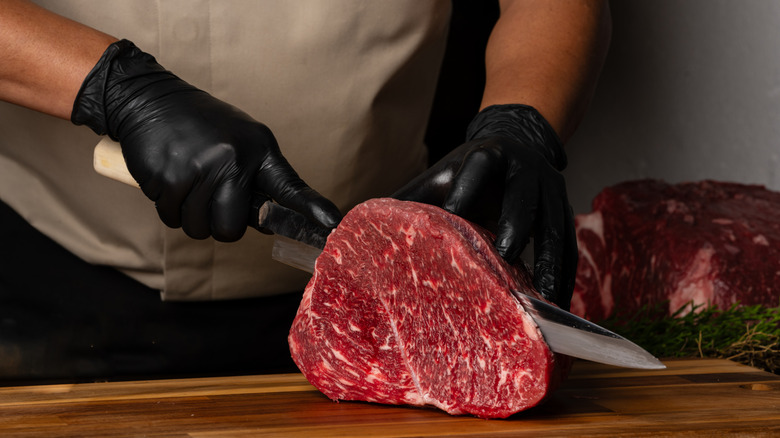 Chef cutting a steak