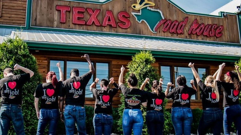 Texas Roadhouse employees lined up outside a franchise wearing matching t-shirts