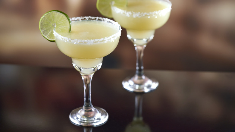 Two classic margaritas in glasses on bar counter