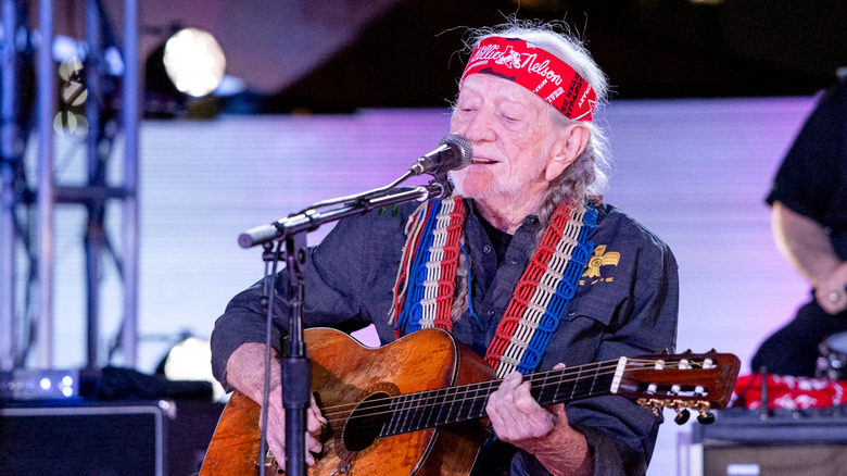 Willie Nelson performing onstage