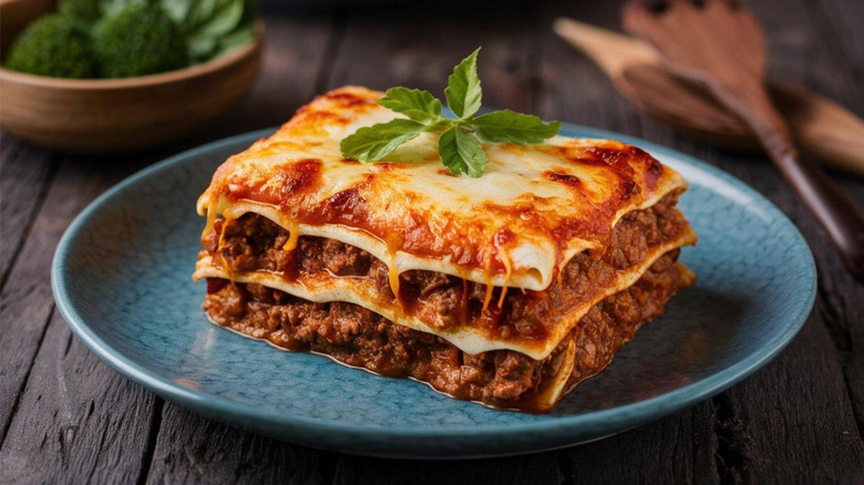 Slice of lasagna on a blue plate