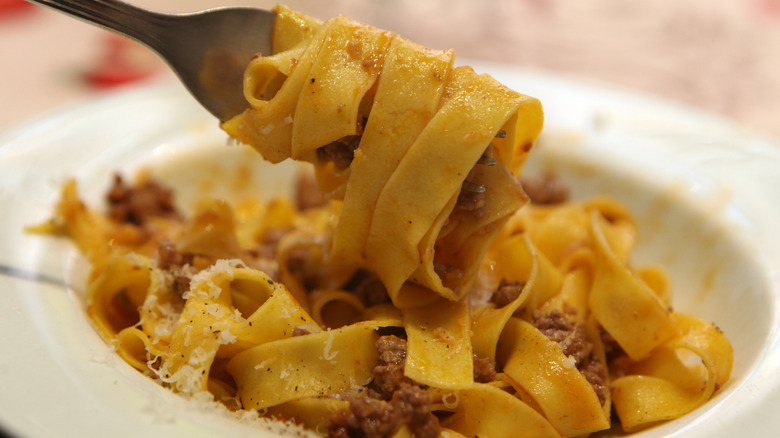 noodles with bolognese on a spoon