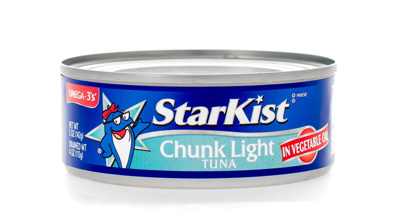A stack of StarKist Chunk Light Tuna in Oil against a white background
