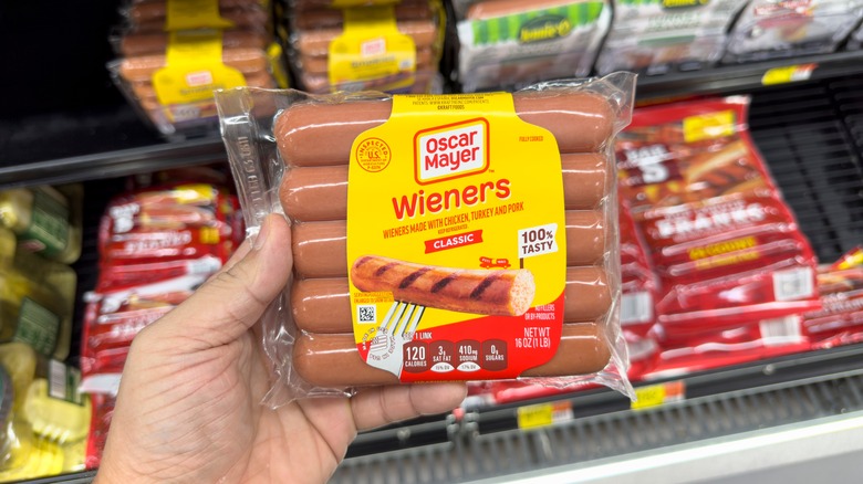 Person holding a package of Oscar Mayer wieners