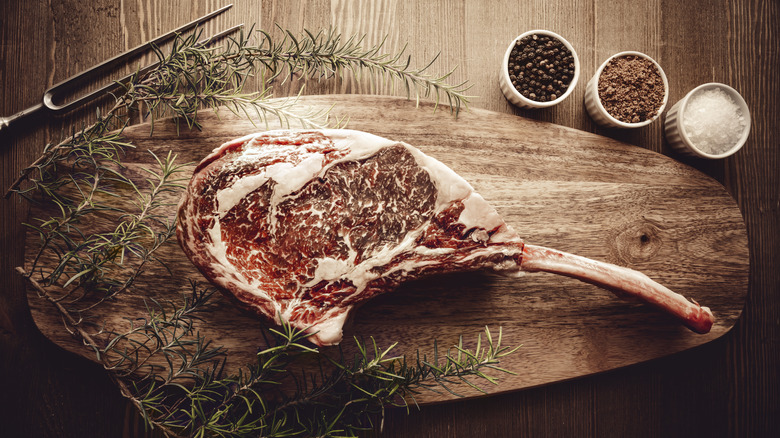 dry aged tomahawk cut on board