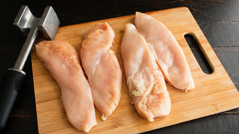 chicken on board with meat mallet