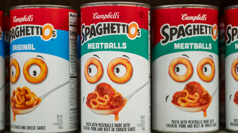Three cans of SpaghettiOs, one original flavor and two with meatballs placed next to each other