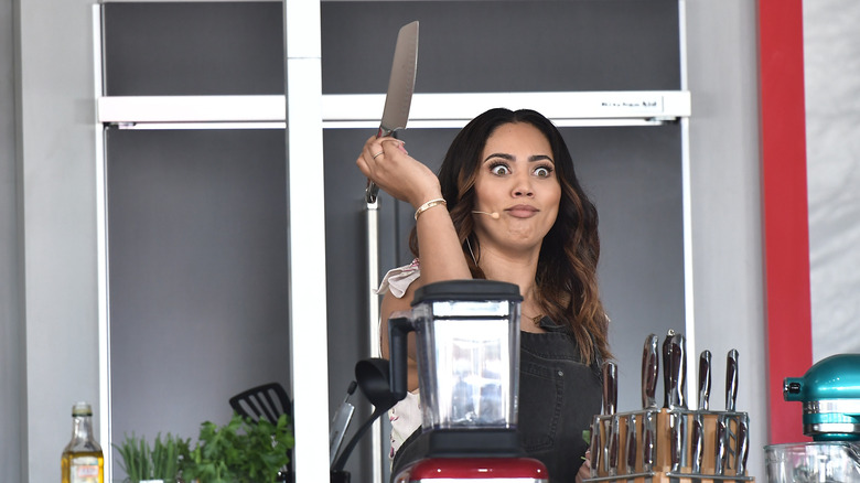 Ayesha Curry holding knife