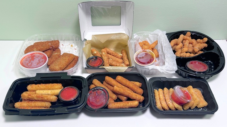Seven chain restaurant mozzarella sticks together on a green and white background