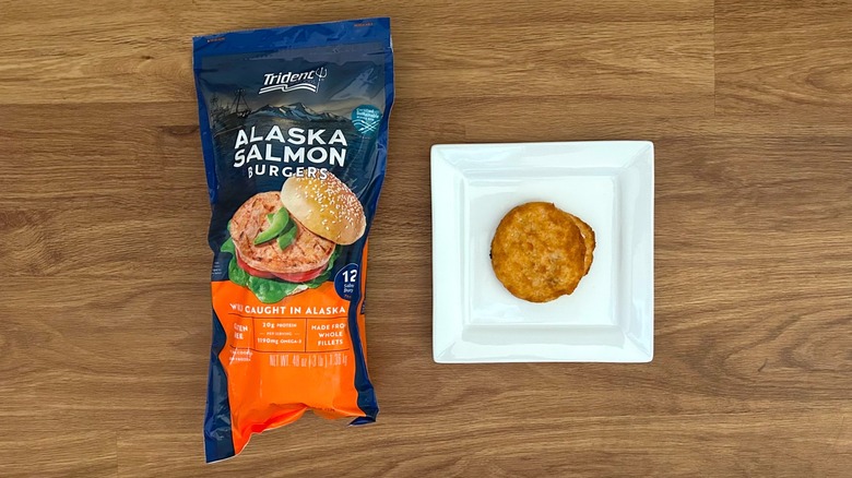 Trident Seafoods Alaskan Salmon Burgers package and prepared burger on white square plate