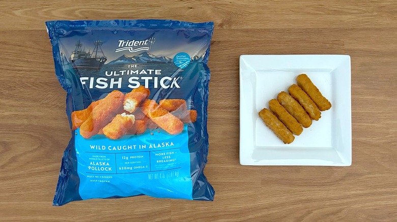 Trident Seafoods The Ultimate Fish Stick package and prepared fish sticks on white square plate