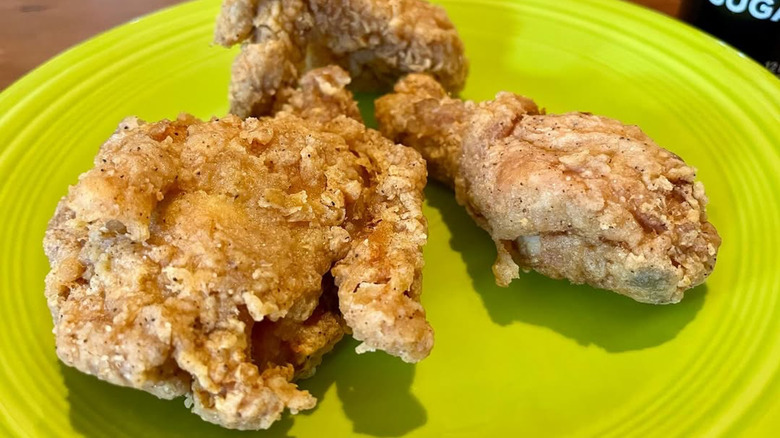 3 pieces of fried chicken on a lime-green plate