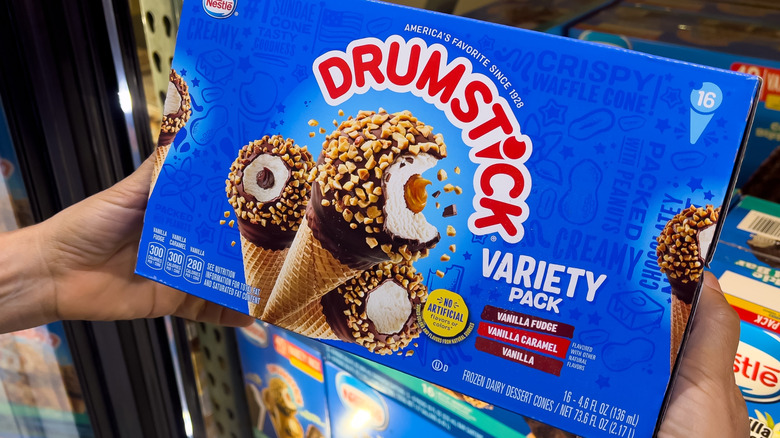 Person holding a Nestle Variety Pack Drumstick box