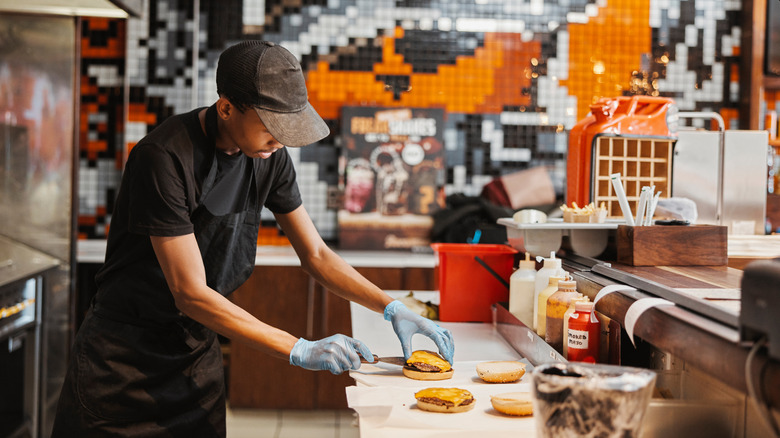 A line cook preparing food in a chain restaurant