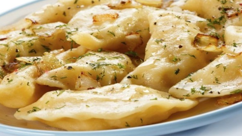Plate of Cheddar-apple dumplings, sprinkled with some dried herbs