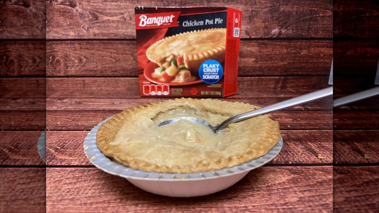 Banquet chicken pot pie with the crust broken by a spoon