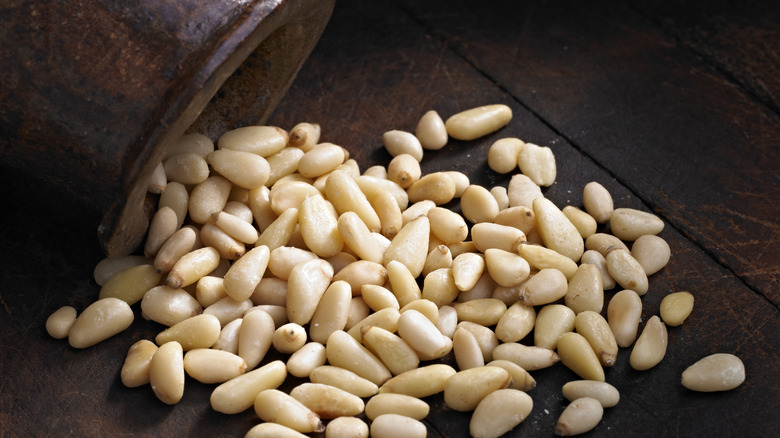 jar dumping out pine nuts