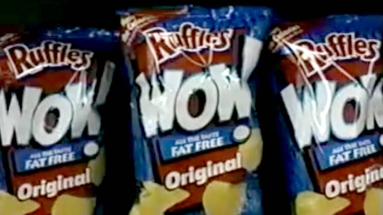 Three bags of Ruffles WOW fat free chips on a grocery shelf