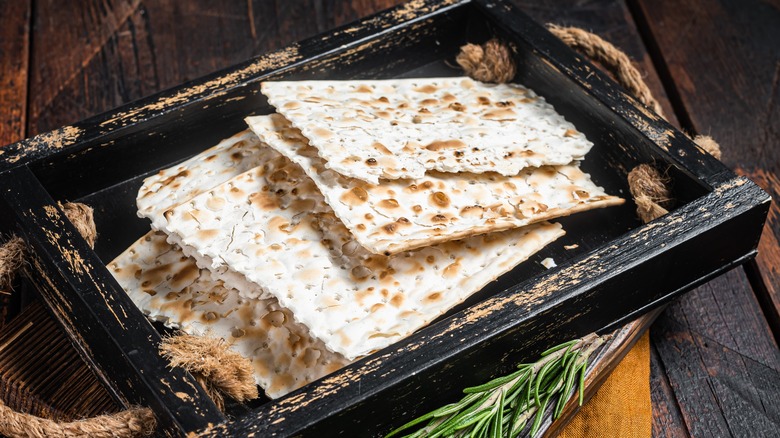 Matzo on a black wood tray