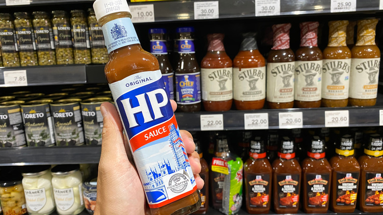 Hand holding bottle of HP Brown Sauce