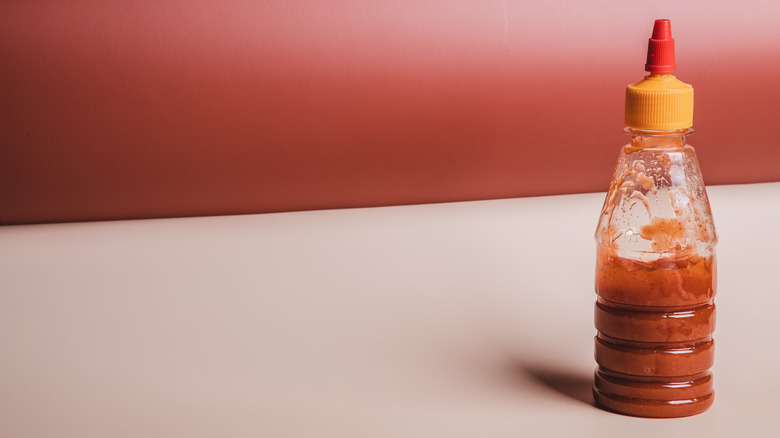 Hot sauce bottle on white table