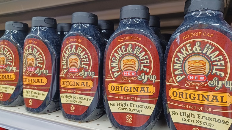 Containers of pancake syrup on store shelf