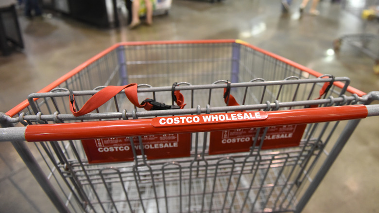 A closeup of a costco shopping cart inside a store.