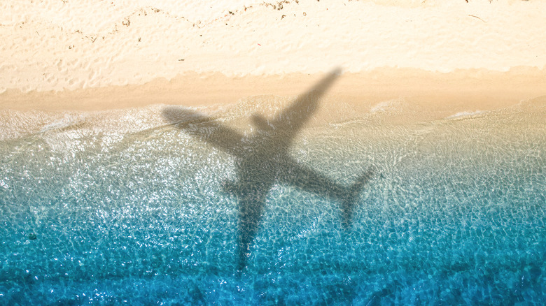 The shadow of plane over a beach, view from above.