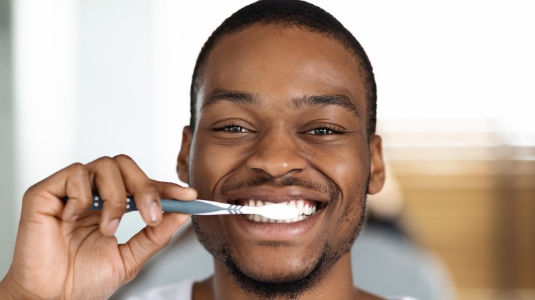 Person brushing teeth