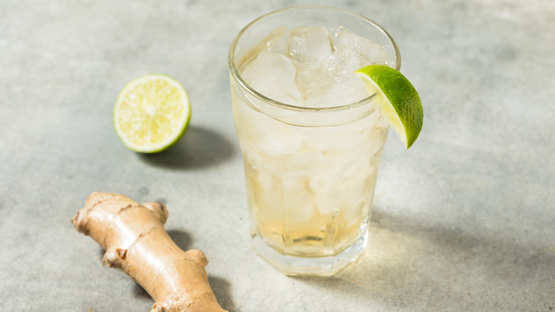 Glass of ginger ale, with lime and fresh ginger