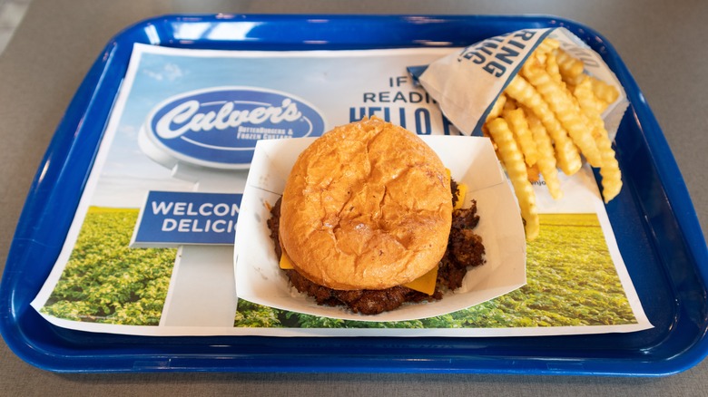 a blue tray at Culver's with a cheeseburger and fries.