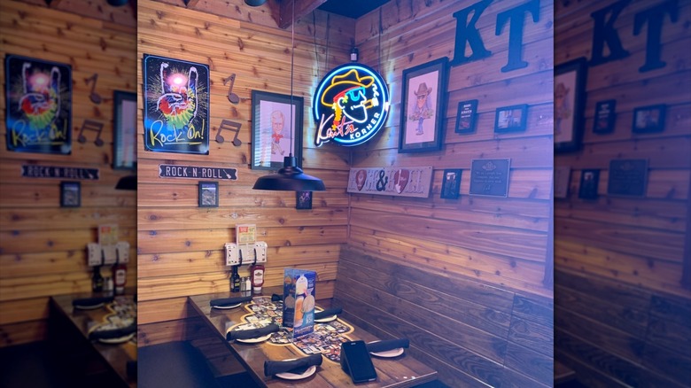 Neon signs and decor on Texas Roadhouse wall