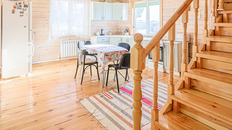 Wood-paneled kitchen with tasseled rug