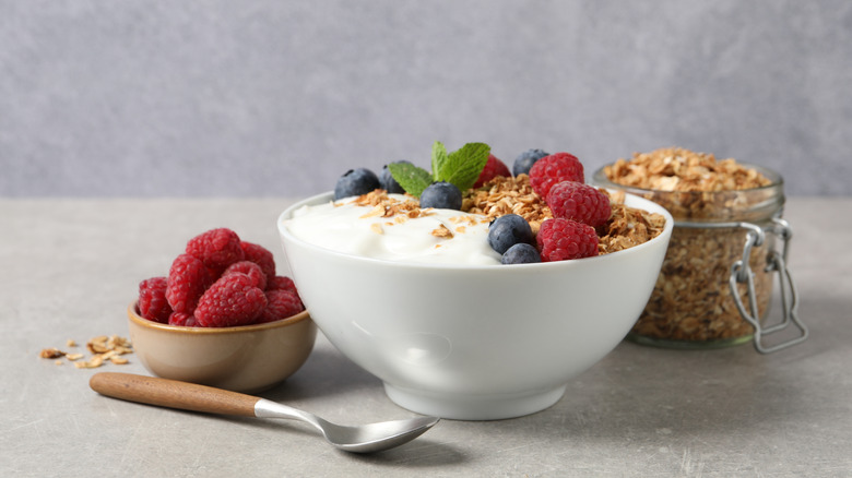 A bowl of yogurt with granola and fruit