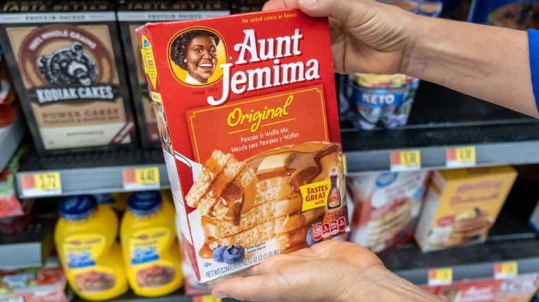 Person holding package of Aunt Jemima pancake and waffle mix