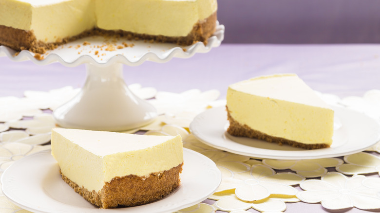 Two slices of vanilla chiffon pie cut and set on white plates.