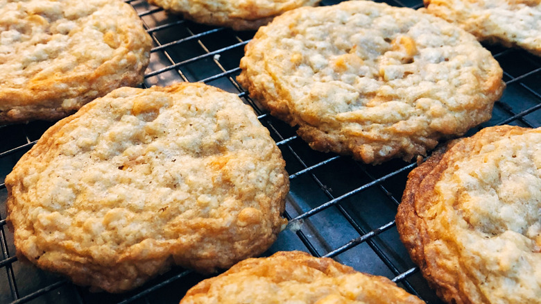 A batch of oatmeal scotchies in cookie form on a wire rack.
