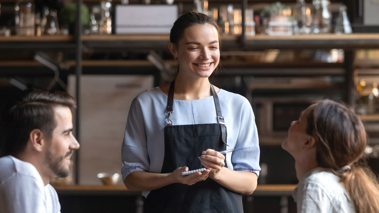 A restaurant server takes an order